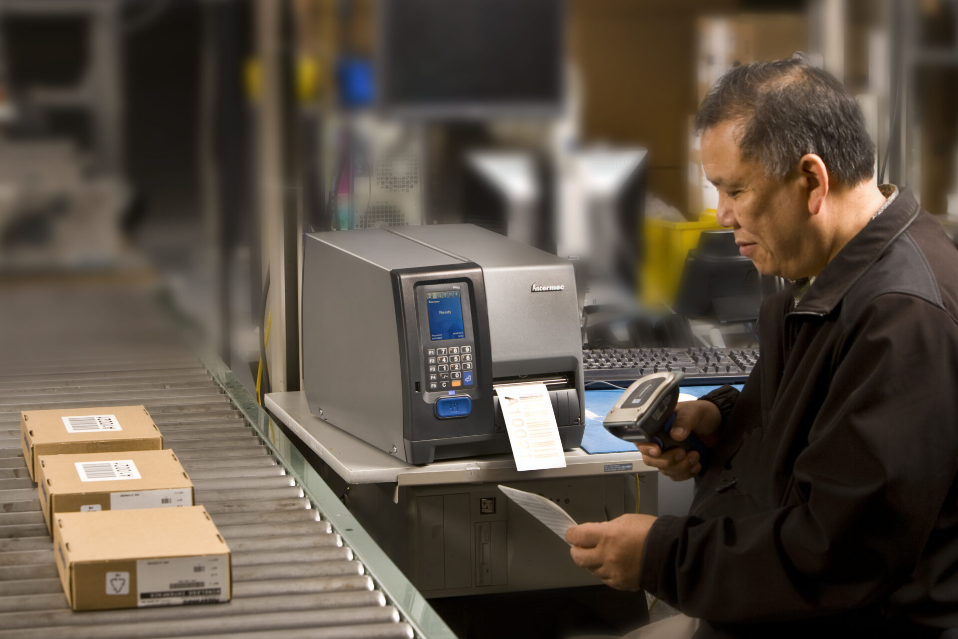 Factory worker using the Honeywell PM43 bar code printer