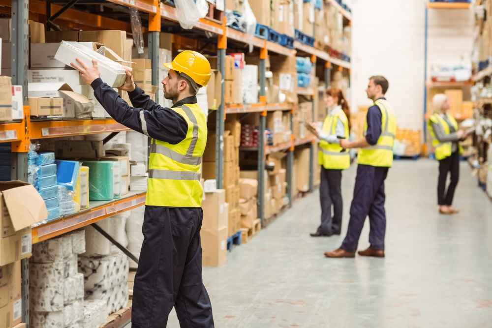 Workers taking product off shelf in warehouse