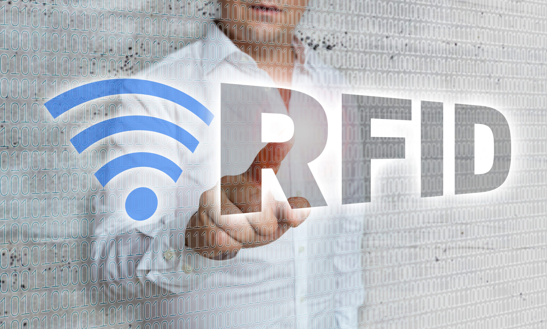 Man in white shirt touching the word RFID on a screen